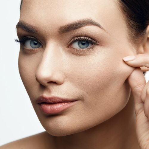 Healthy Skin. Beautiful Woman With Beauty Face Pulling Elastic Facial Skin. High Resolution.