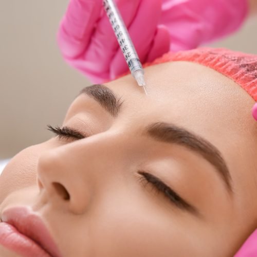 Young woman undergoing treatment in beauty salon, closeup